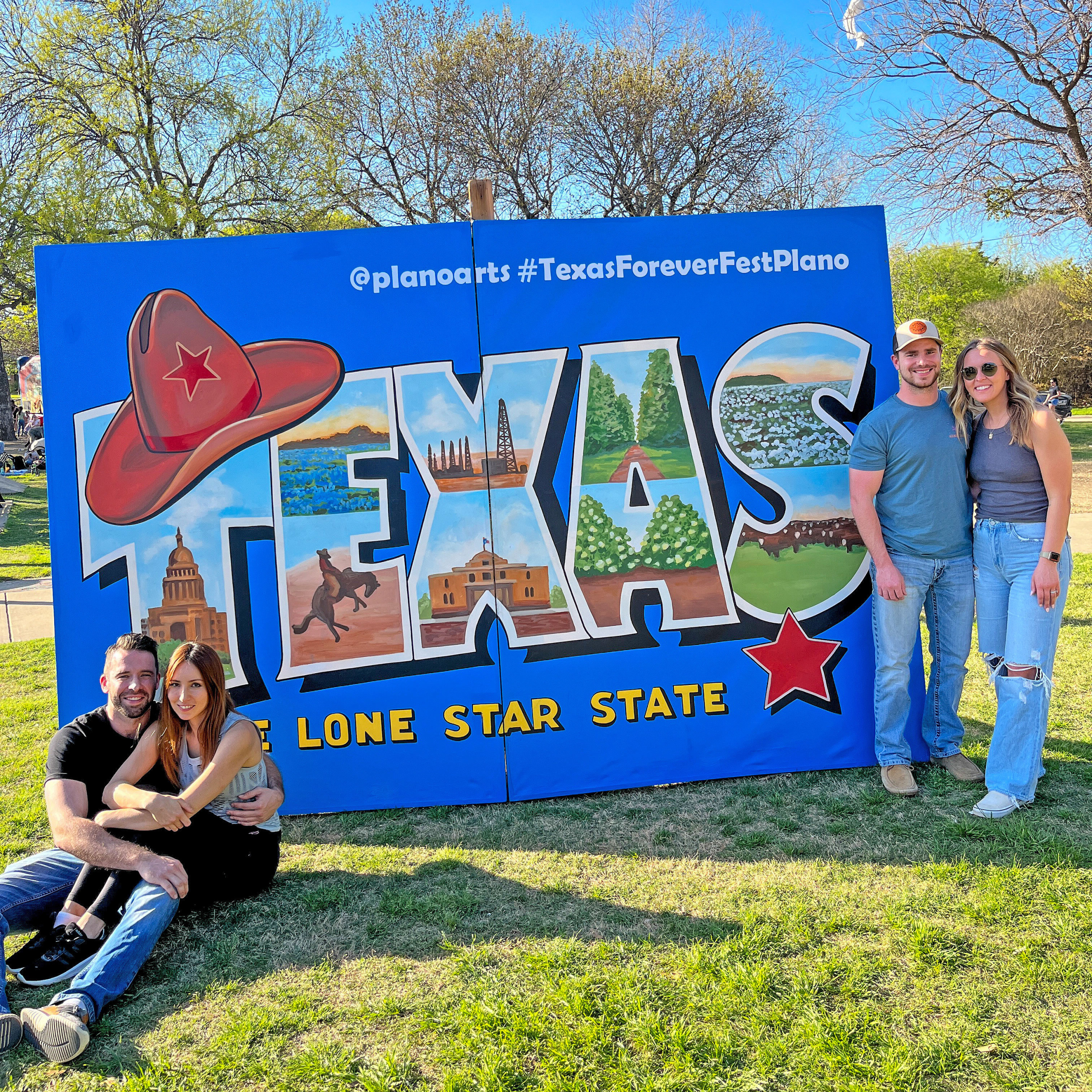 People posing in front of a colorful Texas Forever Fest sign in Plano, Texas.